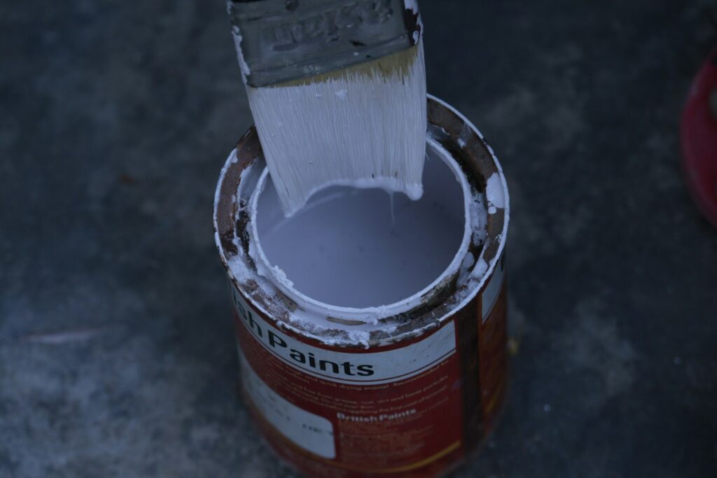 Thick white coating liquid stirred in a can
